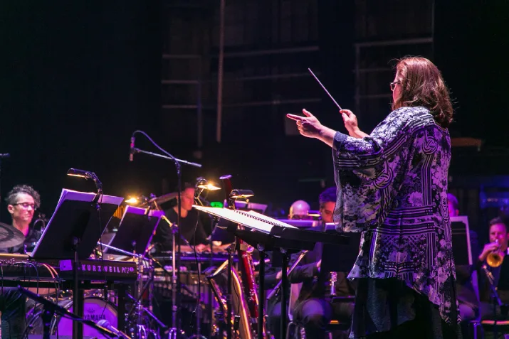 Jessica Wells conducting an orchestra