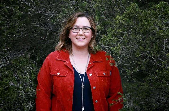 Jessica Wells smiling in front of bushland