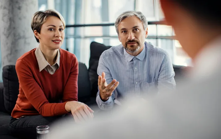A couple discussing their challenges with a family lawyer