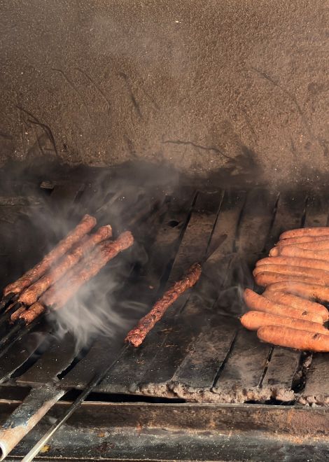 Perfectly seasoned kofta sizzling over an open fire.