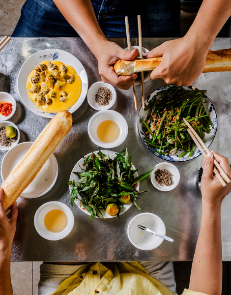 Breaking fresh bread over snails and crunchy morning glory