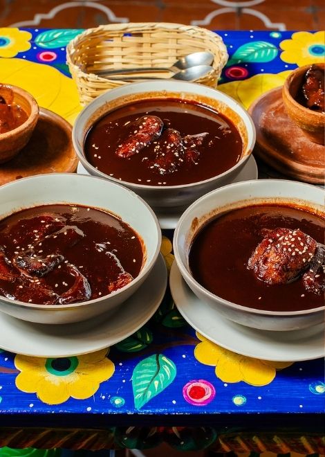 Rich, velvety Guatemalan mole layered with deep, complex flavours.