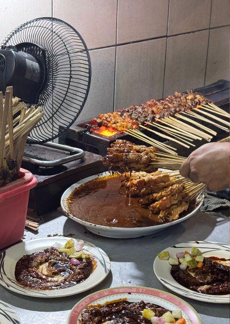 The unmistakable aroma of charcoal-grilled satay.