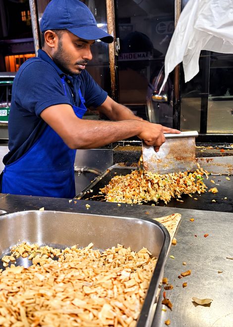 The unmistakable sound of kottu being chopped, tossed and fried.