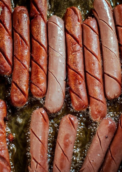 Hot dogs sizzling away, ready for the bun.