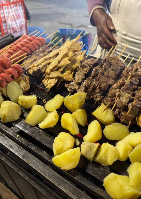 Smoky late-night anticuchos sizzling over the grill