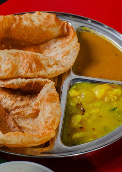 Golden poori with warmly spiced potato masala.