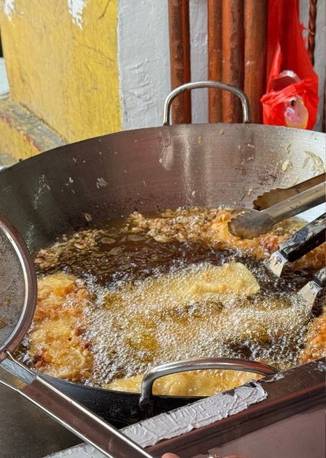 The irresistible aroma of jackfruit fritters fresh from the fryer.