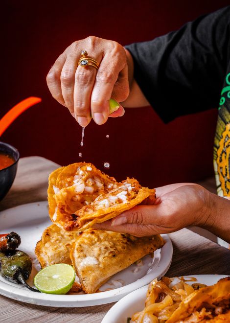 Goat birria taco with a squeeze of lime