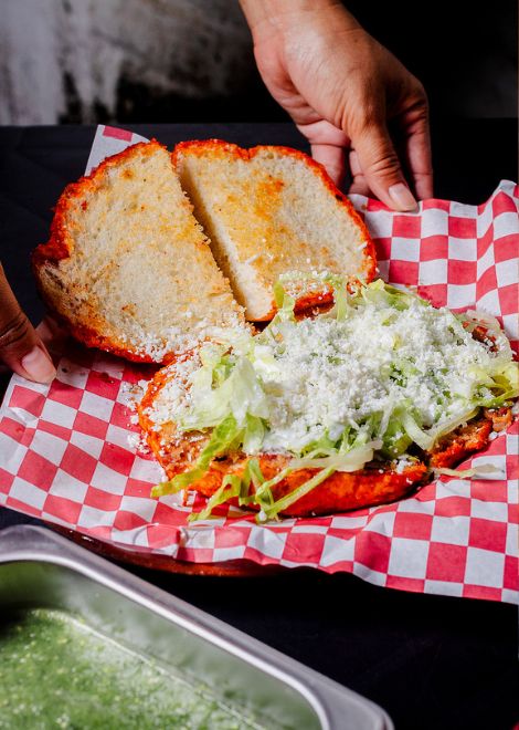 Pambazo, torta dipped in chile and stuffed with potatoes and chorizo