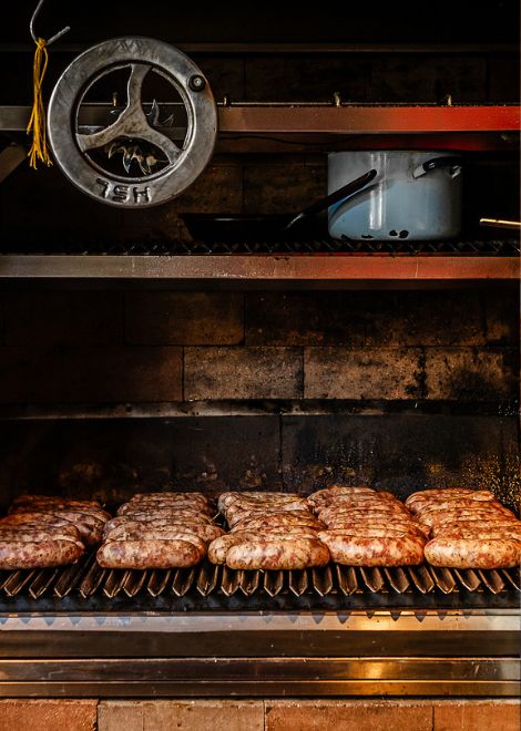 The smell of sausages cooking over hot coals is impossible to ignore