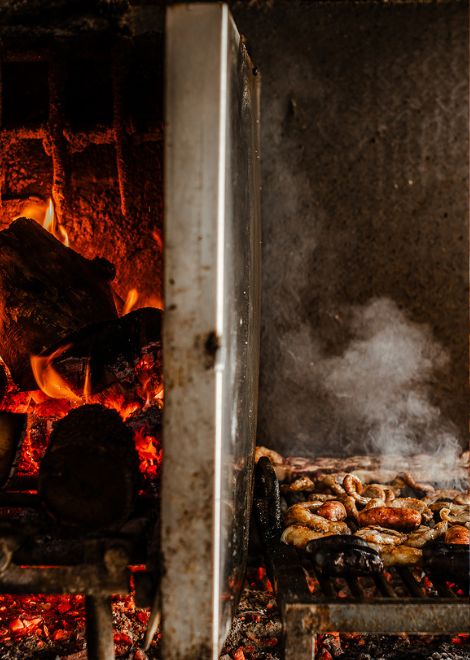 The crackle of fire and the aroma of grilling meat