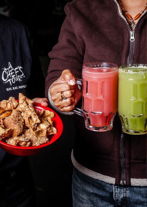 Cheers with a glass of locally-made pulque