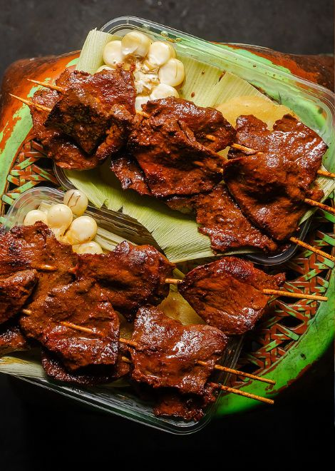 Perfectly grilled anticuchos cooked over glowing charcoal.