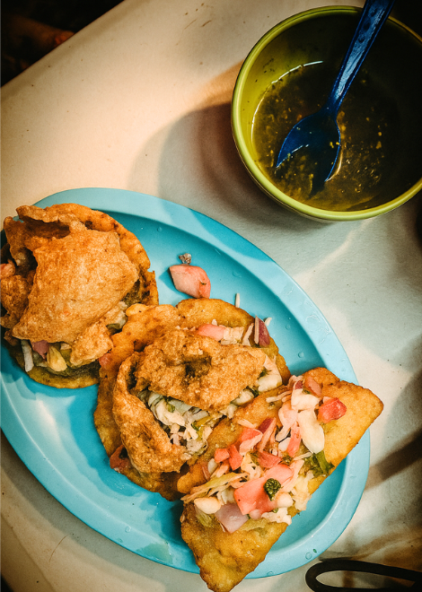 Freshly fried Mexican empanadas stuffed with cheese and topped with kastikan fried pork 