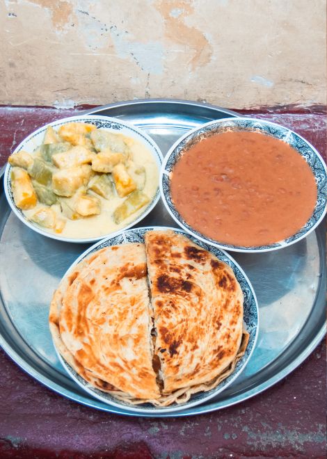 Coconut-rich maharagwe ya nazi and boga la nazi with flaky chapatis.
