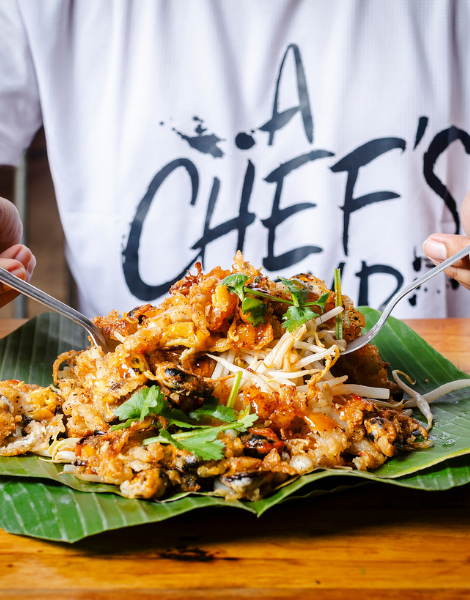 Crispy oyster pancake served on banana leaf