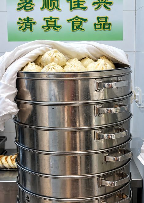 Towers of steaming beef baozi, stacked high in the steamer.