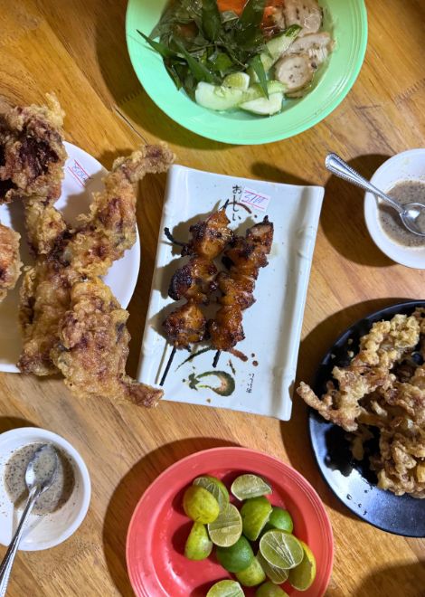 Charcoal-grilled chicken alongside golden, crispy frog.