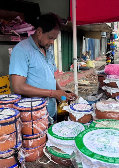 A local curd seller among the bustle of Pettah.