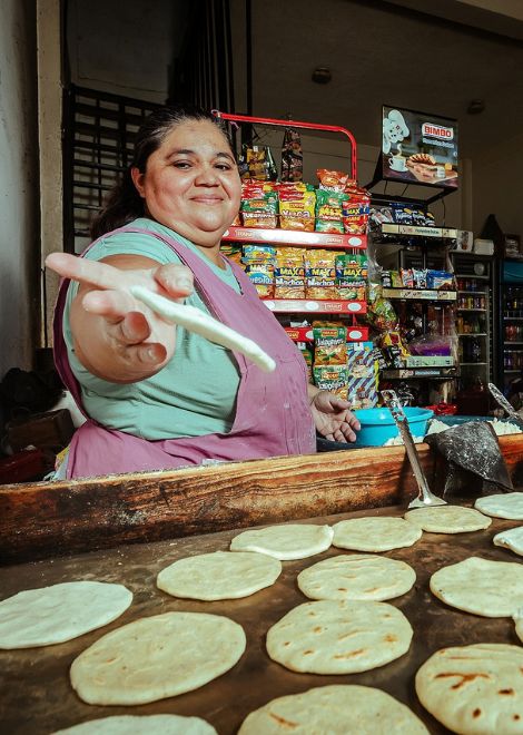 Flipping warm corn tortillas on the comal. 