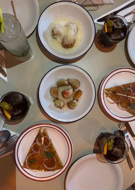 Small Argentine plates with a glass of vermouth and soda
