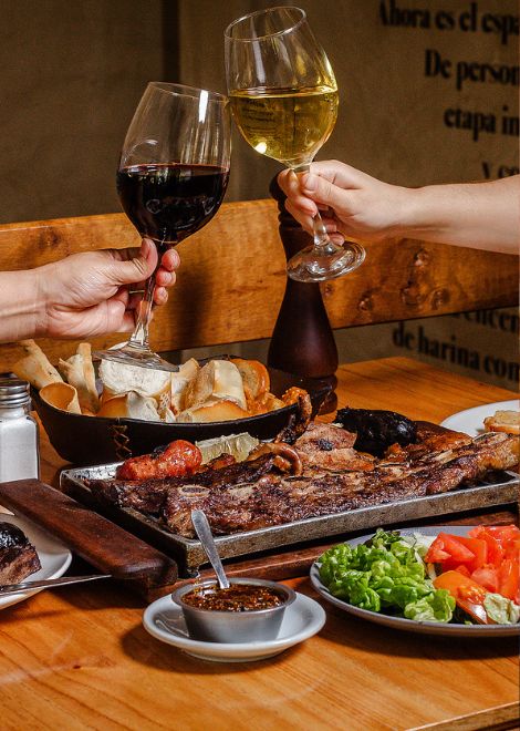 A mixed asado grill paired with a glass of Mendoza's world-famous Malbec