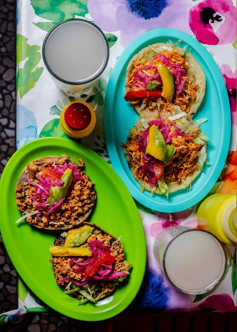 Crispy Yucatán panucho topped with ground beef and avocado