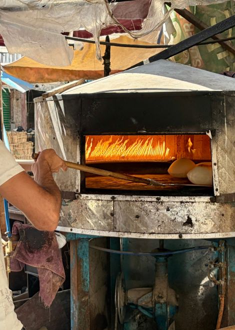 Blistered baladi bread, fresh from the oven.
