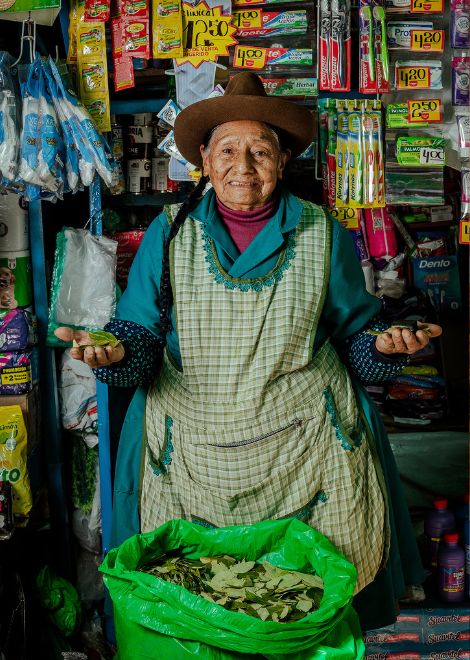 An elderly vendor sells coca leaves, a tradition that has been part of life in the Andes for thousands of years