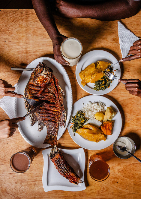 Ugandan fried tilapia fish with traditional Ugandan sides