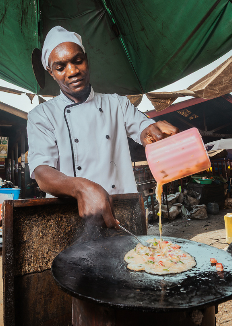 Vendor cooking Uganda's famous Rolex in Bugalobi Market