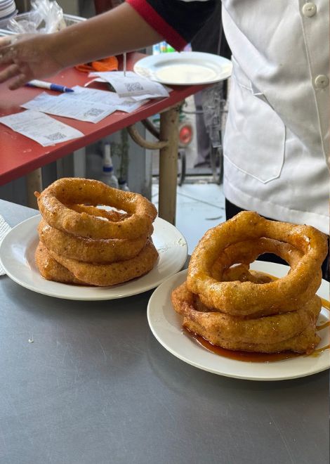 Crispy golden buñuelos stacked high at a neighbourhood favourite