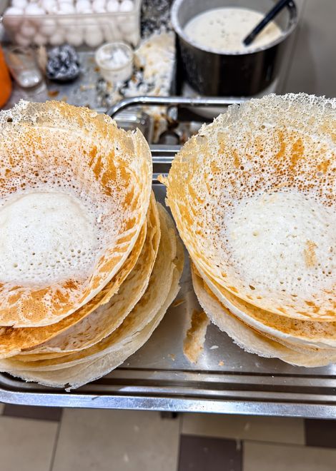 The iconic egg hopper, with its delicate, crispy edges and golden yolk.