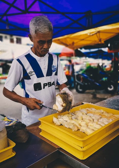 Carving up durian fruit ready for the evening