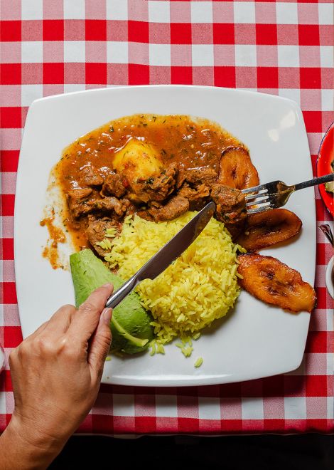 A hearty bowl of seco de chivo, deeply spiced and slow-cooked.