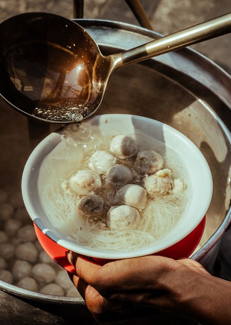 Tender beef meatballs swimming in a rich, aromatic bakso broth.
