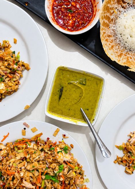 Chicken kottu with creamy kiri hodi coconut gravy and crisp egg hoppers.