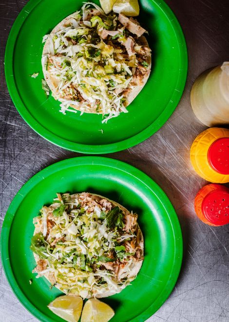 Tender, slow-cooked pork lechón tacos with house salsa 