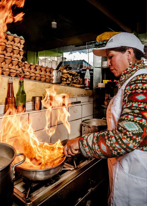 Flames leap from the pan as lomo saltado is cooked to order, one of Peru's most iconic dishes