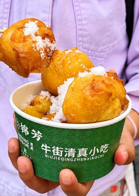 Conclude on a sweet note with sugar-dusted fried cream cakes.
