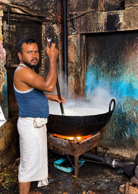Stirring giant cauldrons of boiling milk at the paneer makers.
