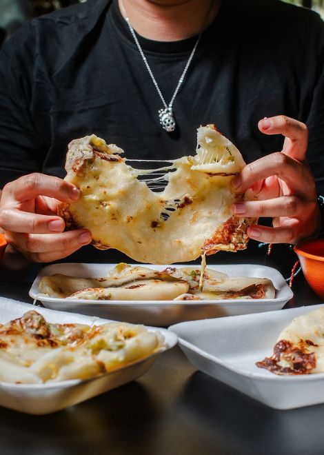 That irresistible pupusa cheese pull.