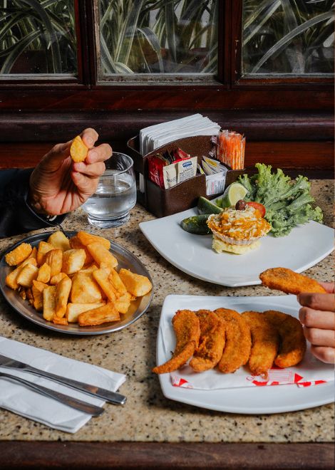 Rich crab au gratin served with crispy breaded bananas and cassava drenched in melted butter