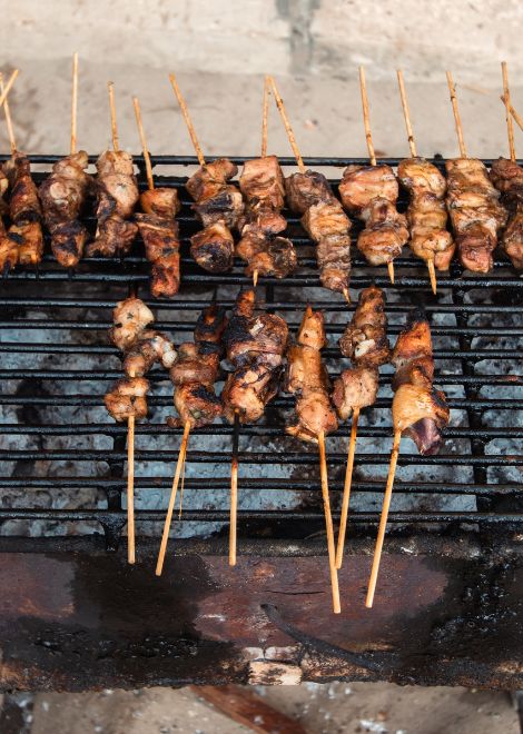 Freshly grilled skewers cooked over glowing beachside coals.