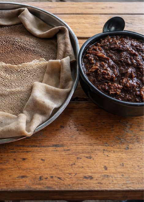 Duba quanta, dried and spiced squash stew with tangy injera
