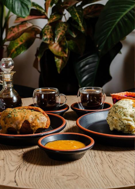 Cheesy bolón de verde paired with a crisp fish-filled corviche.