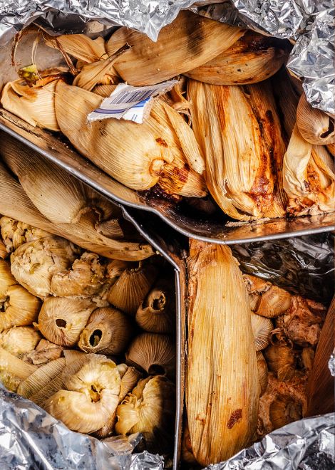 Freshly steamed tamales wrapped in corn husks
