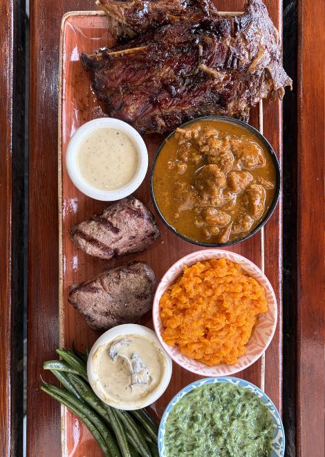 South African game meat platter with kudu, ostrich and sticky barbecue warthog ribs
