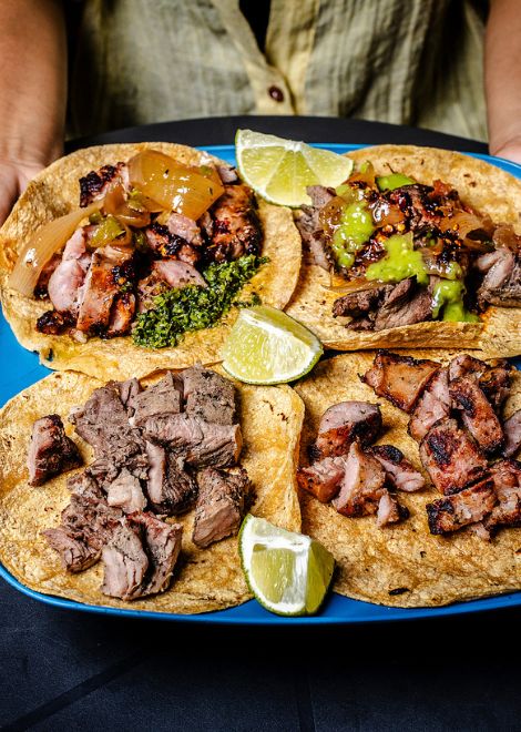 Steak and pork sausage tacos with piquant salsa and a squeeze of lime